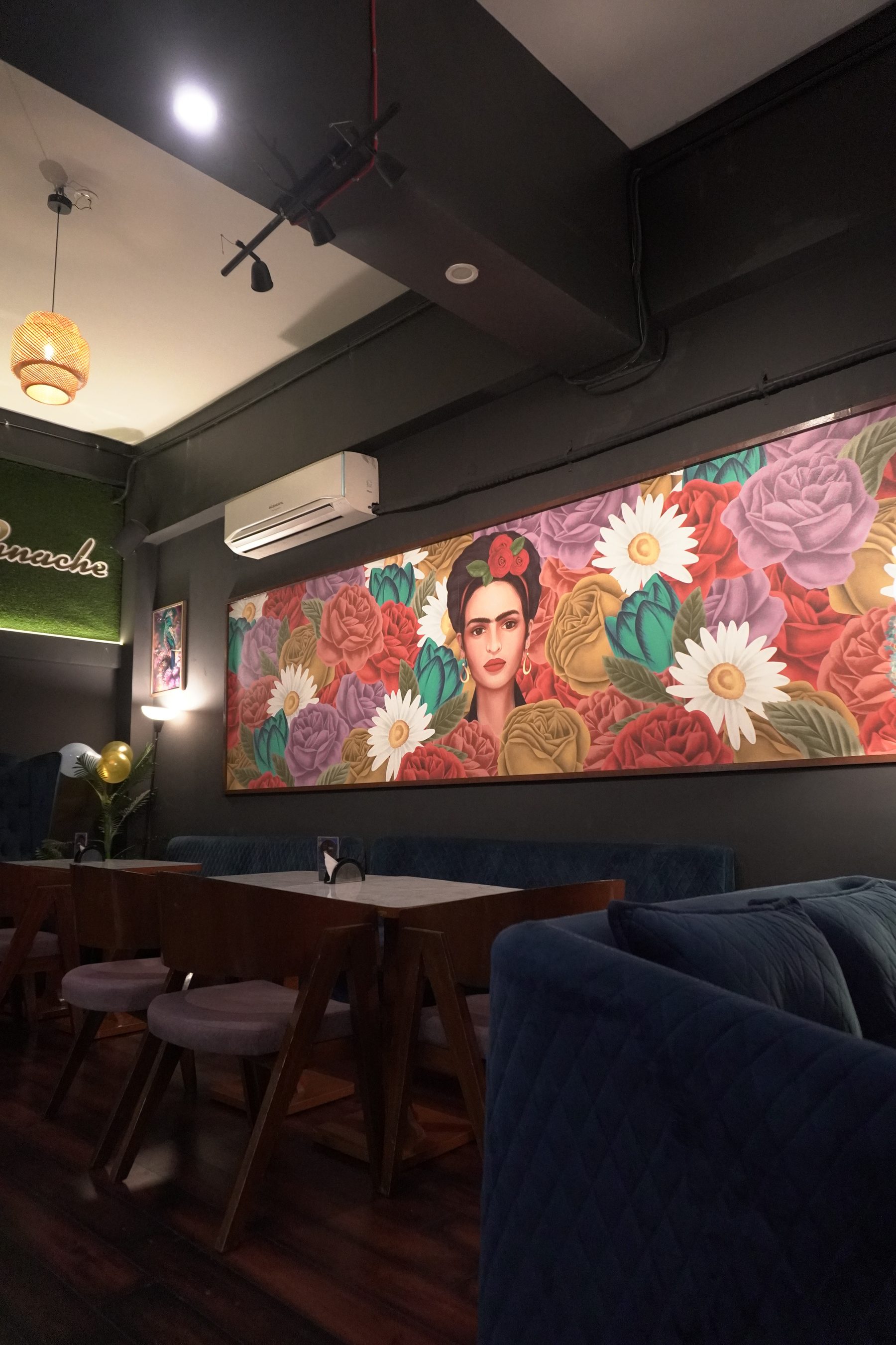 The navy lounge seating and floral mural wall at Panache